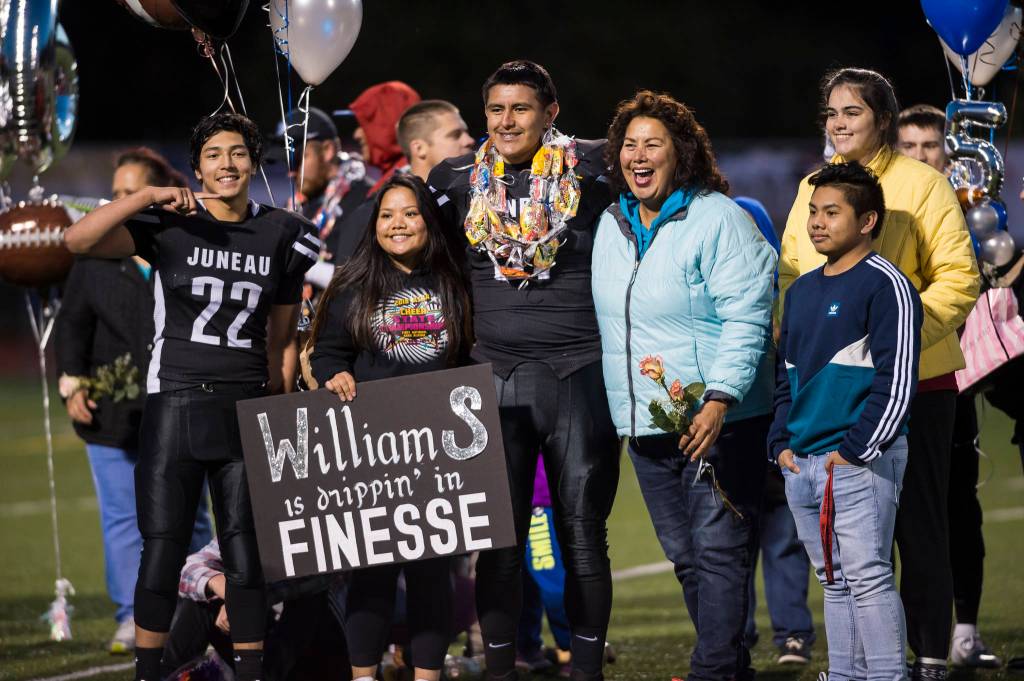 Family and friends celebrate senior night with cheerleaders and players before Juneau Uniteds game against Colony at Thunder Mountain High School on Friday, Sept. 21, 2018. (Michael Penn | Juneau Empire)