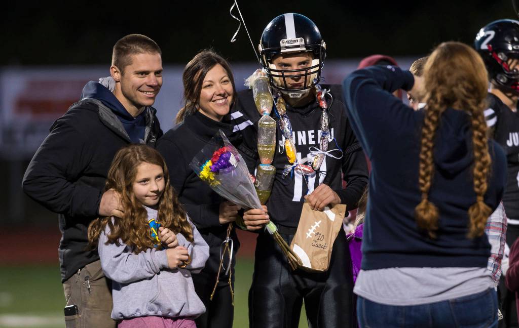 Family and friends celebrate senior night with cheerleaders and players before Juneau Uniteds game against Colony at Thunder Mountain High School on Friday, Sept. 21, 2018. (Michael Penn | Juneau Empire)