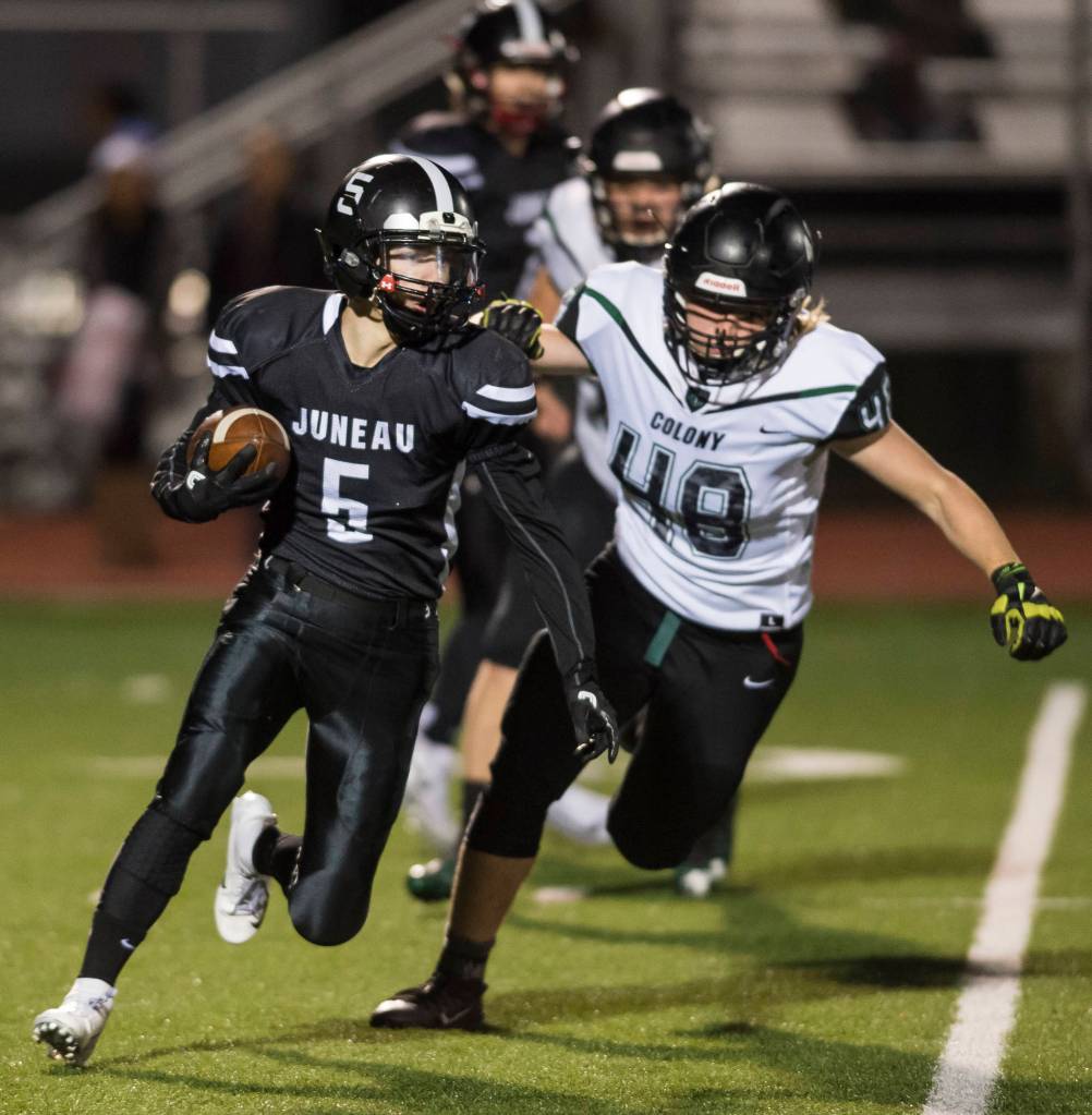 Juneau Uniteds Hansel Hinckle, left, is chased by Colonys Isaac Richardson at Thunder Mountain High School on Friday, Sept. 21, 2018. (Michael Penn | Juneau Empire)