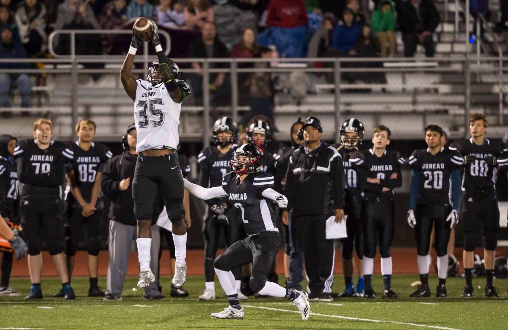 Colonys Julian McPhail, left, intersepts a pass meant for Juneau Uniteds Cristian Batac at Thunder Mountain High School on Friday, Sept. 21, 2018. (Michael Penn | Juneau Empire)