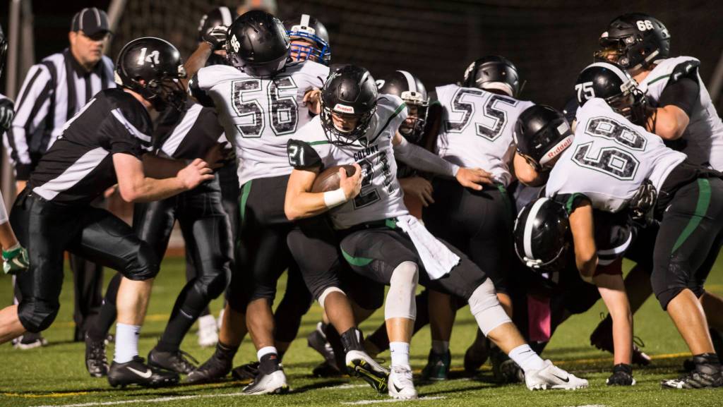 Colonys quarterback Eric Christy pushes his way into the end zone against Juneau United at Thunder Mountain High School on Friday, Sept. 21, 2018. The touchdown was called back because of a penalty. (Michael Penn | Juneau Empire)