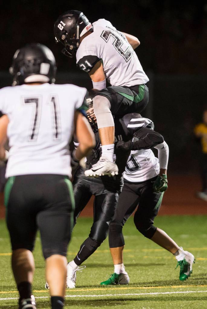 Colonys quarterback Eric Christy hurtles a Juneau United player for a touchdown at Thunder Mountain High School on Friday, Sept. 21, 2018. The touchdown was called back because of a penalty. (Michael Penn | Juneau Empire)