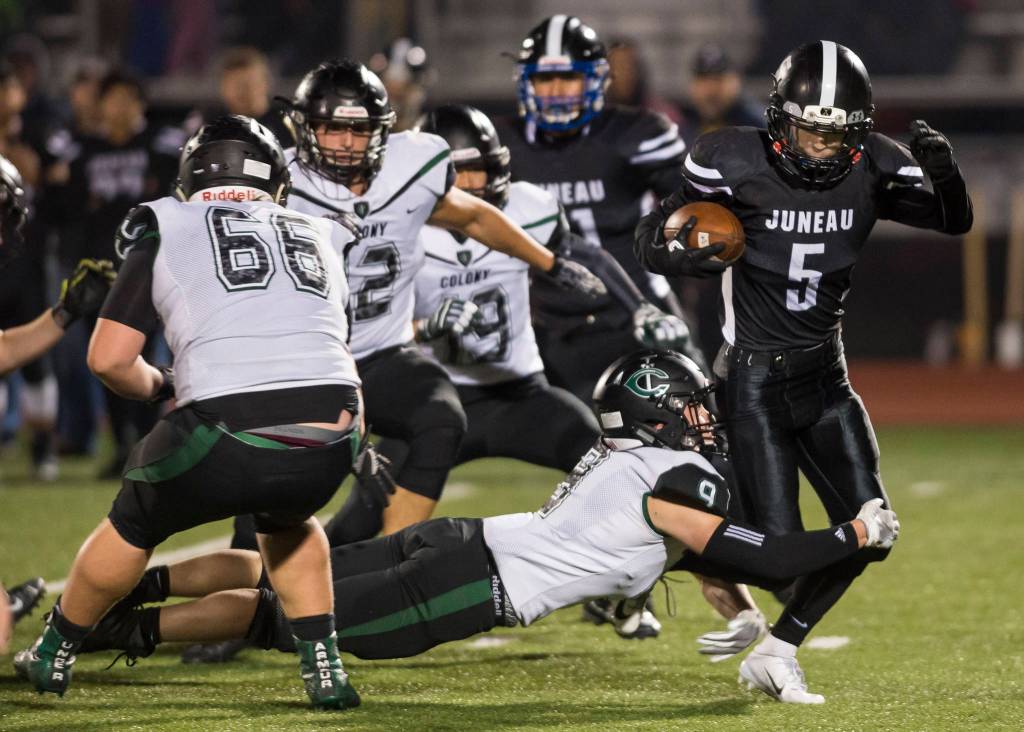 Juneau Uniteds Hansel Hinckle is tackled behind the line of scrimmage by Colonys Trace Severson at Thunder Mountain High School on Friday, Sept. 21, 2018. (Michael Penn | Juneau Empire)