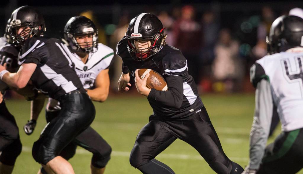 Juneau Uniteds quarterback Cooper Kriegmont runs against Colony at Thunder Mountain High School on Friday, Sept. 21, 2018. (Michael Penn | Juneau Empire)