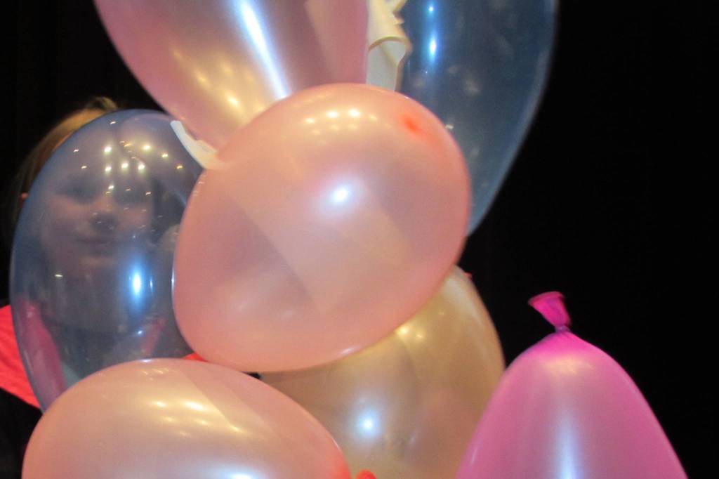 Lydia Heidemann, 11, peers through a mostly transparent blue balloon during Introduce a Girl to Engineering Day. The event is a collaboration between ExxonMobil and Girl Scouts of Alaska, and offers girls a chance to get some hands-on engineering experience. This is the first year the event has taken place in Juneau. (Ben Hohenstatt | Capital City Weekly)