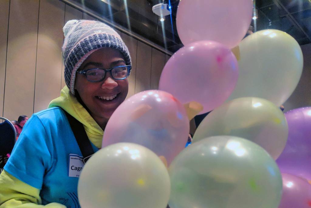 Cagney Davis, 11, smiles while her team puts together a balloon tower using nothing except for balloons and masking tape. The group challenge kicked off Introduce a Girl to Engineering Day at Centennial Hall. (Ben Hohenstatt | Capital City Weekly)