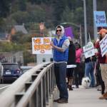 William Musser waves to passing cars on the Douglas Bridge on Saturday, Sept. 22, during the Hands Across the Bridge event, which aims to spread awareness about substance use recovery in Juneau. (Kevin Gullufsen | Juneau Empire)