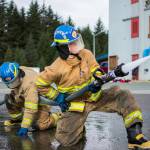 JDHS student Finn Adam (left) and homeschool student James Zuiderduin (right), Capital City Fire/Rescue cadets, practice advancing a hose under pressure at their final day of training with the CCFD on Saturday, April 21, 2018. (Richard McGrail | Juneau Empire File)