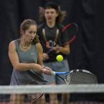 Adelie McMillan volleys a ball against the team of Olivia Moore and River Reyes-Boyles during the Regional Tennis Championships at the JRC/The Alaska Club on Saturday. McMillian is backed up by her partner Wolf Dostal in the mixed doubles match. (Michael Penn | Juneau Empire)