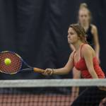 Erica Hurtte volleys a ball against the team of Olivia Moore and Adelie McMillan during the Regional Tennis Championships at the JRC/The Alaska Club on Saturday. Hurtte and Jaymie Collman, background, won the womans double final. (Michael Penn | Juneau Empire)