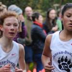 Juneau-Douglas High Schools Annika Schwartz, left, and Trinity Jackson compete in the Region V Cross Country Running Championships Division I race on the Treadwell Mine Historic Trails on Saturday. (Nolin Ainsworth | Juneau Empire)