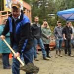 Mayor Ken Koelsch digs a shovel full of dirt at a Wednesday dedication ceremony for Jackie Street Cottages, an affordable housing project in Lemon Creek. (Kevin Gullufsen | Juneau Empire)