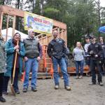 Juneau School District Career and Technical Education Coordinator Carin Smolin, left, laughs with a group gathered to celebrate the groundbreaking of a student-built neighborhood of affordable Lemon Creek homes called the Jackie Street Cottages on Wednesday, Sept. 26, 2018. (Kevin Gullufsen | Juneau Empire)
