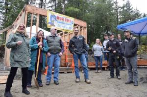 Juneau School District Career and Technical Education Coordinator Carin Smolin, left, laughs with a group gathered to celebrate the groundbreaking of a student-built neighborhood of affordable Lemon Creek homes called the Jackie Street Cottages on Wednesday, Sept. 26, 2018. (Kevin Gullufsen | Juneau Empire)