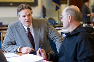 Sen. Mike Dunleavy, R-Wasilla, left, speaks with Sen. Click Bishop, R-Fairbanks, before a Senate Finance Committee meeting in 2014. (Michael Penn | Juneau Empire File)