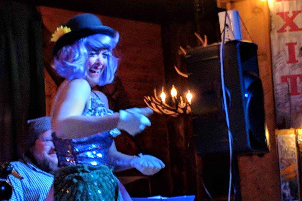 Anya Absten mimes pulling a rope during Nude & Rude Revue burlesque troupes Thursday night show. (Ben Hohenstatt | Capital City Weekly)