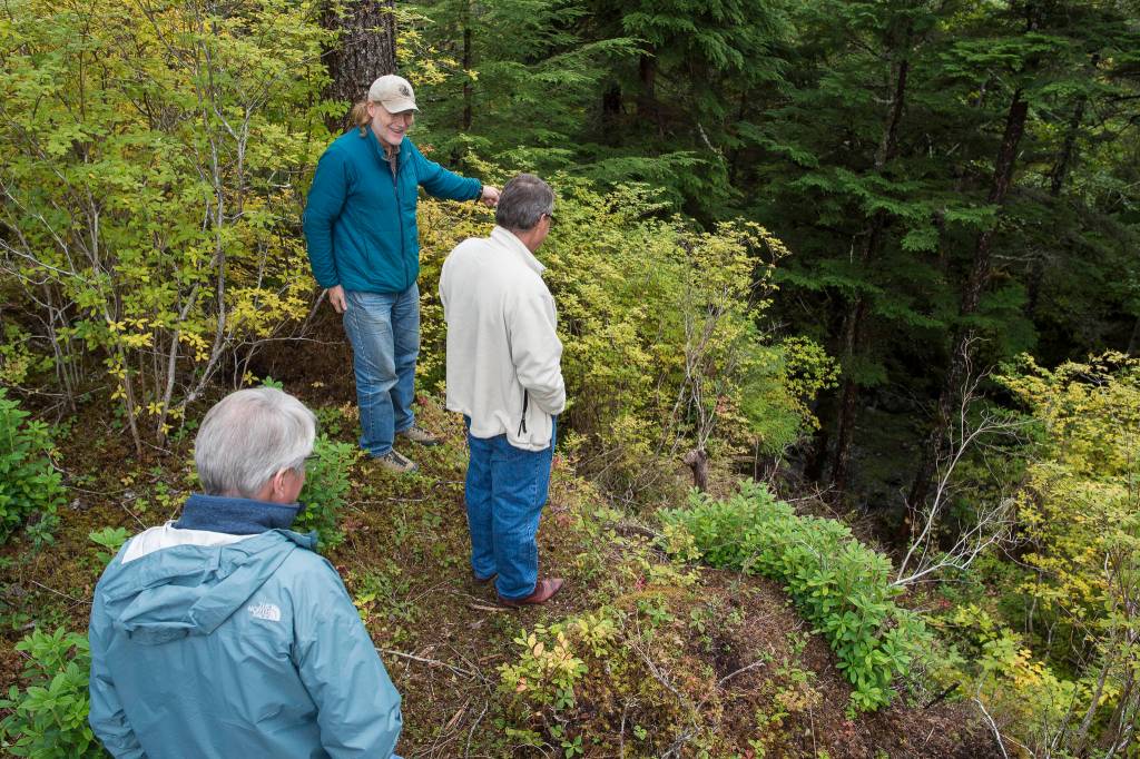 Alan Steffert, project manager for the city, shows City Manager Rorie Watt and Win Gruening Middle Creek from the end of the newly opened West Douglas Pioneer Road after a ribbon cutting ceremony on Friday, Sept. 28, 2018. (Michael Penn | Juneau Empire)