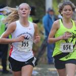 Juneau-Douglas Sadie Tuckwood leads South Anchorages Ava Earl in the ASAA/First National Bank Alaska Division I girls state cross country meet at the Bartlett High School running trails on Saturday. (Michael Dinneen | For the Juneau Empire)