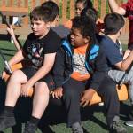 Kids test out some of the new play equipment on Saturday at Project Playground. (Kevin Gullufsen | Juneau Empire)
