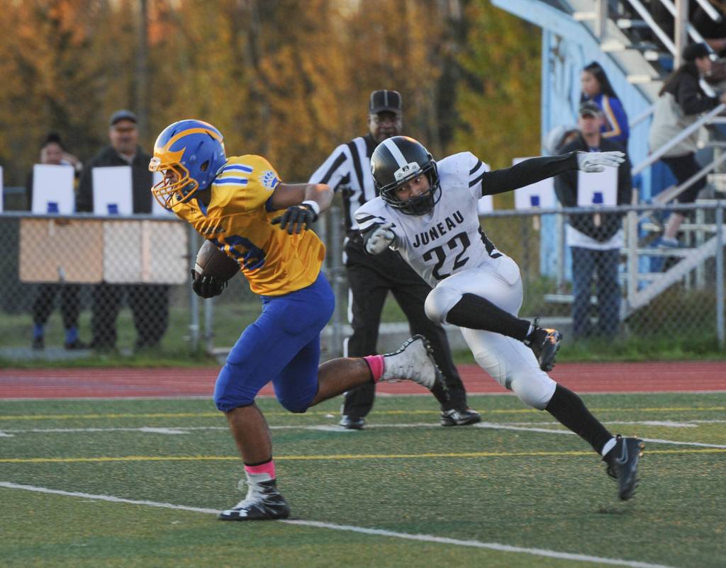 Juneau Uniteds Ali Beya reaches for Bartletts Matuu Ah Sam at Chugiak High School in Anchorage on Saturday, Sept. 29. Bartlett won 65-12. (Michael Dinneen | For the Juneau Empire)