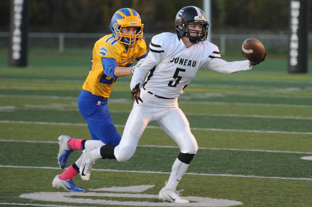 Juneaus Hansel Hinckle reaches for a pass as Bartlett defender Josh Siania closes in at Chugiak High School in Anchorage on Saturday, Sept. 29. Bartlett won 65-12. (Michael Dinneen | For the Juneau Empire)