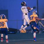 Juneau Uniteds Hansel Hinckle reaches for a pass as Bartlett defender Josh Siania closes in at Chugiak High School in Anchorage on Saturday, Sept. 29. Bartlett won 65-12. (Michael Dinneen | For the Juneau Empire)