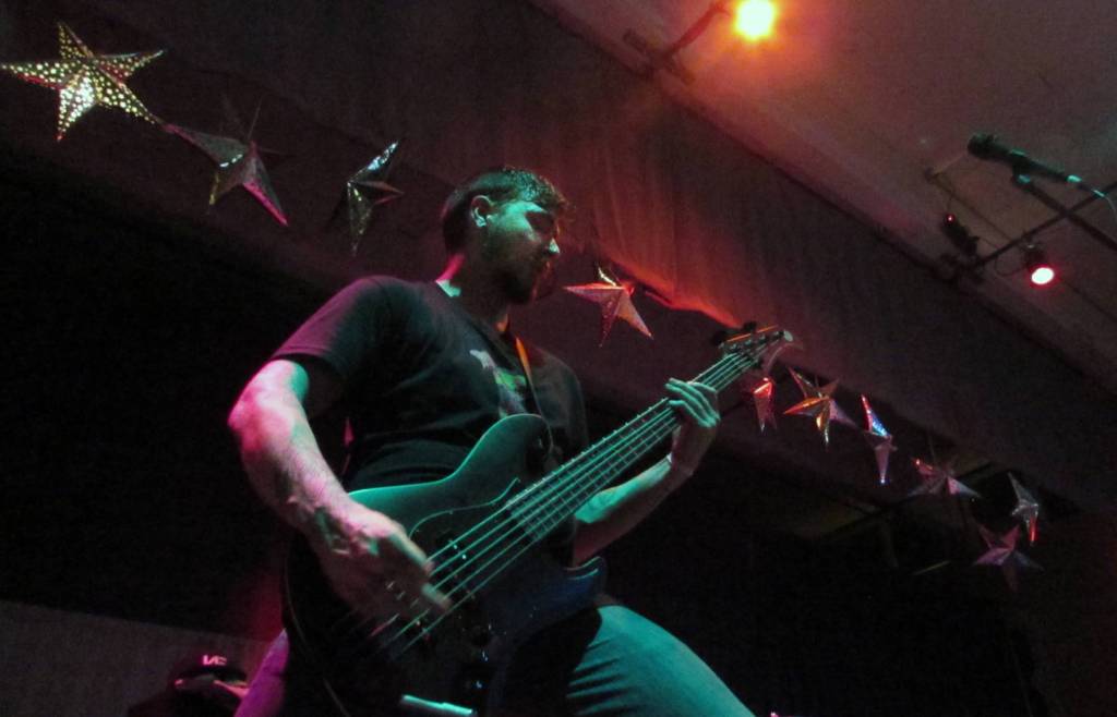 Trentyn Days, bassist for Distance Defined, plays during the Fall Freakshow concert at Juneau Arts & Culture Center. Trentyns brother, Trevyn, plays guitar for Distance Defined, both brothers are originally from Juneau. Their Mother, Cassandra Days, was head banging and singing along in the audience.