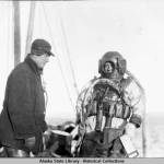 Diver in helmet and diving suit, preparing to descend to the Princess Sophia. (Alaska State Library Historical Collection, ASL-P87-1718)