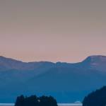 A cruise ship heads for Stephens Passage as the moon rises over the Coastal Mountain range on Thursday. (Michael Penn | Juneau Empire)