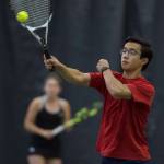 River Reyes-Boyles volleys a ball against the team of and Adelie McMillan and Wolf Dostal during the Regional Tennis Championships at the JRC/The Alaska Club on Saturday, Sept. 22, 2018. Reyes_Boyles is backed up by partner Jaymie Collman, background, in the mixed double match. (Michael Penn | Juneau Empire)
