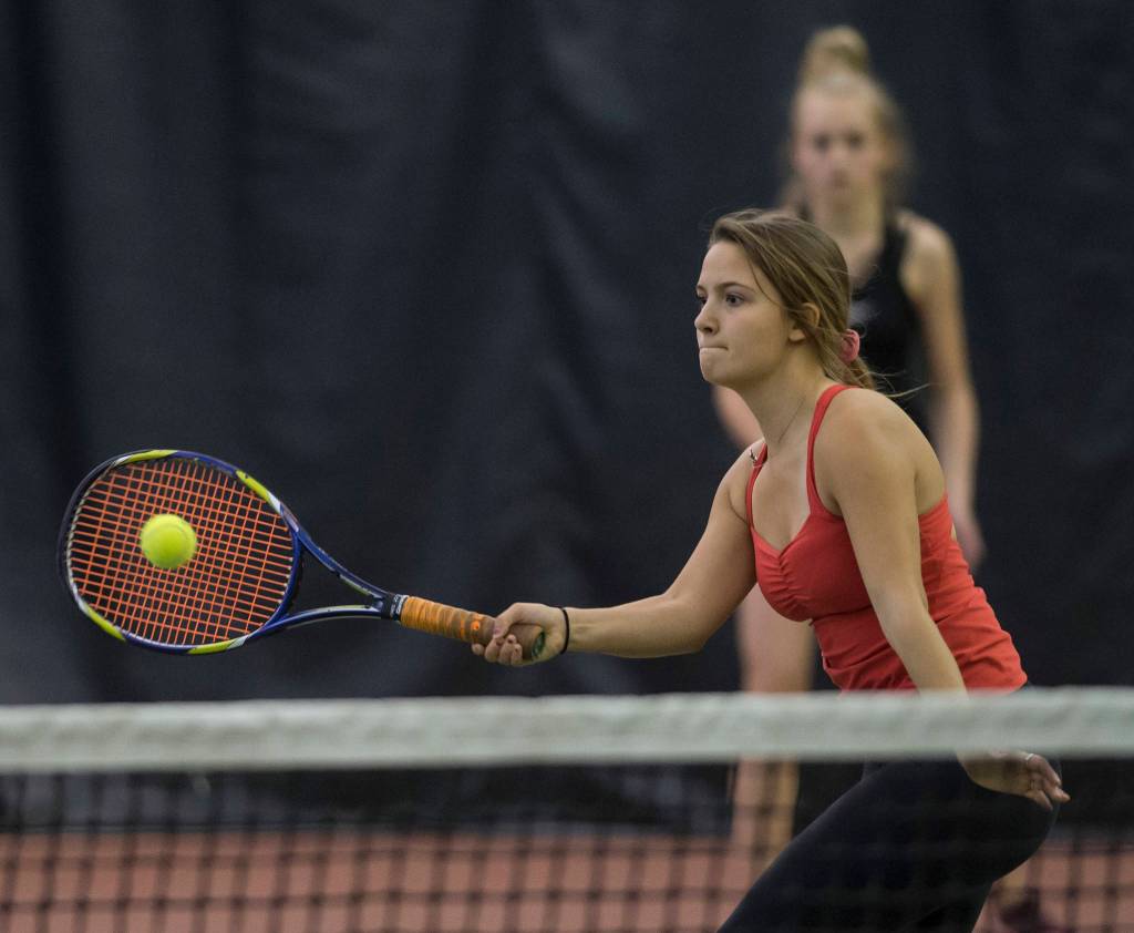 Erica Hurtte volleys a ball against the team of Olivia Moore and Adelie McMillan during the Regional Tennis Championships at the JRC/The Alaska Club on Saturday, Sept. 22, 2018. Hurtte and Jaymie Collman, background, won the womans double final. (Michael Penn | Juneau Empire)