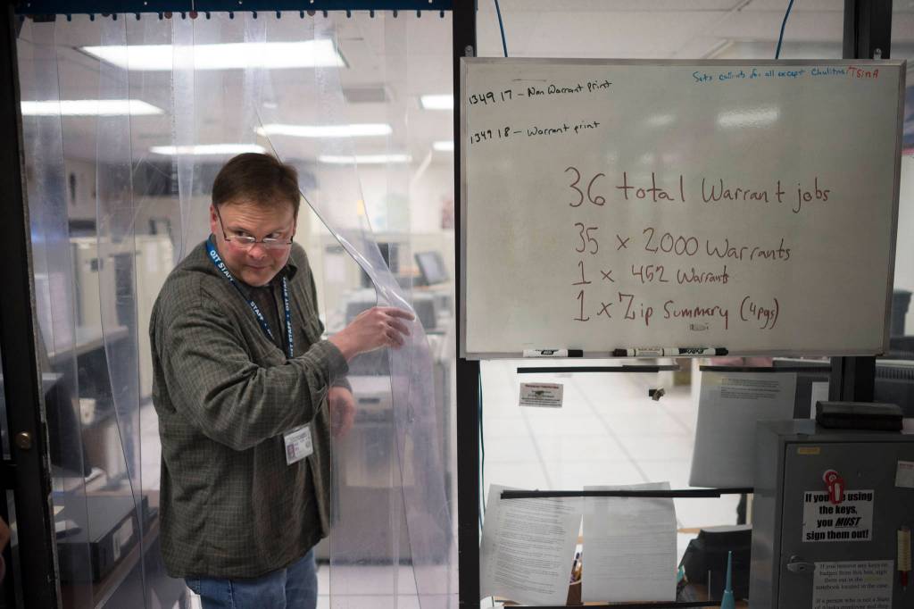 Eric Essary, data processing production manager for the states information technology department, leads the way into the states secure printing facility as Permanent Fund Dividend checks were being printed on Tuesday, Sept. 25, 2018. (Michael Penn | Juneau Empire)