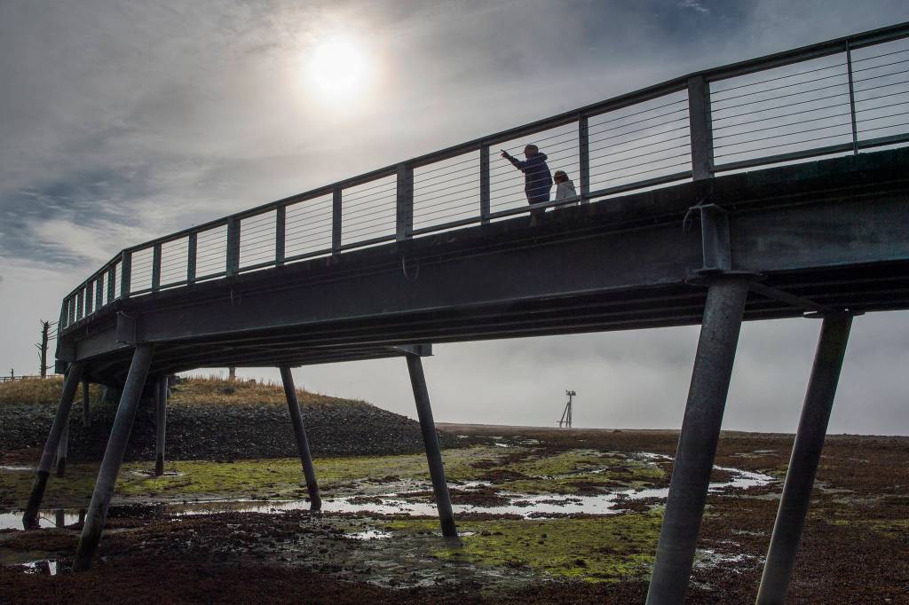 People walk along the Seawalk as the fog burns off downtown on Thursday, Sept. 27, 2018. (Michael Penn | Juneau Empire)