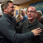 Assembly District 2 candidates Garrett Schoenberger, left, and Wade Bryson greet each other during Election night in the Assembly chambers on Tuesday, Oct. 2, 2018. (Michael Penn | Juneau Empire)