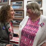 Mayoral candidate Saralyn Tabachnick, left, congratulates Mayor-elect Beth Weldon after watching Election results come in at the Assembly chambers on Tuesday, Oct. 2, 2018. (Michael Penn | Juneau Empire)
