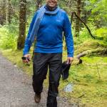 Oct. 21, 2018 Dirk Younkerman loves Alaska and has regularly visited and seasonally worked here since 1993. I ran into him on the trail on a rainy day where he was out enjoying the temperate rainforest. His practical clothes also looked smarta royal blue Columbia fleece shirt, Kathmandu rain pants from New Zealand, Xtratufs, merino wool neck scarf and buff. An avid videographer, his most important accessories are his video camera and his ever-present smile, which reveals how much he enjoys Juneau.