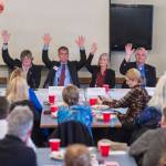 Juneau legislative candidates raise their hands to show they are in favor of a second crossing to Douglas Island during a forum at the Juneau Chamber of Commerce luncheon at the Moose Lodge on Thursday, Oct. 4, 2018. From left: House District 33 candidates Chris Dimond and Sara Hannan, House District 34 candidates Jerry Nankervis and Andi Story, and Senate District Q candidates Don Etheridge and Jesse Kiehl. (Michael Penn | Juneau Empire)