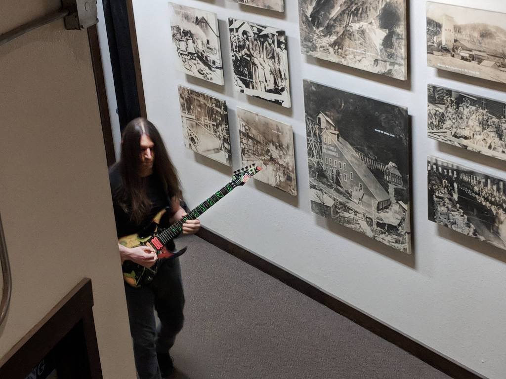 Ward F. Ward warms up in the hallway in the Emporium building before taking the stage at the Goldtown Theater for the Joy of Strings. (Ben Hohenstatt | Capital City Weekly)