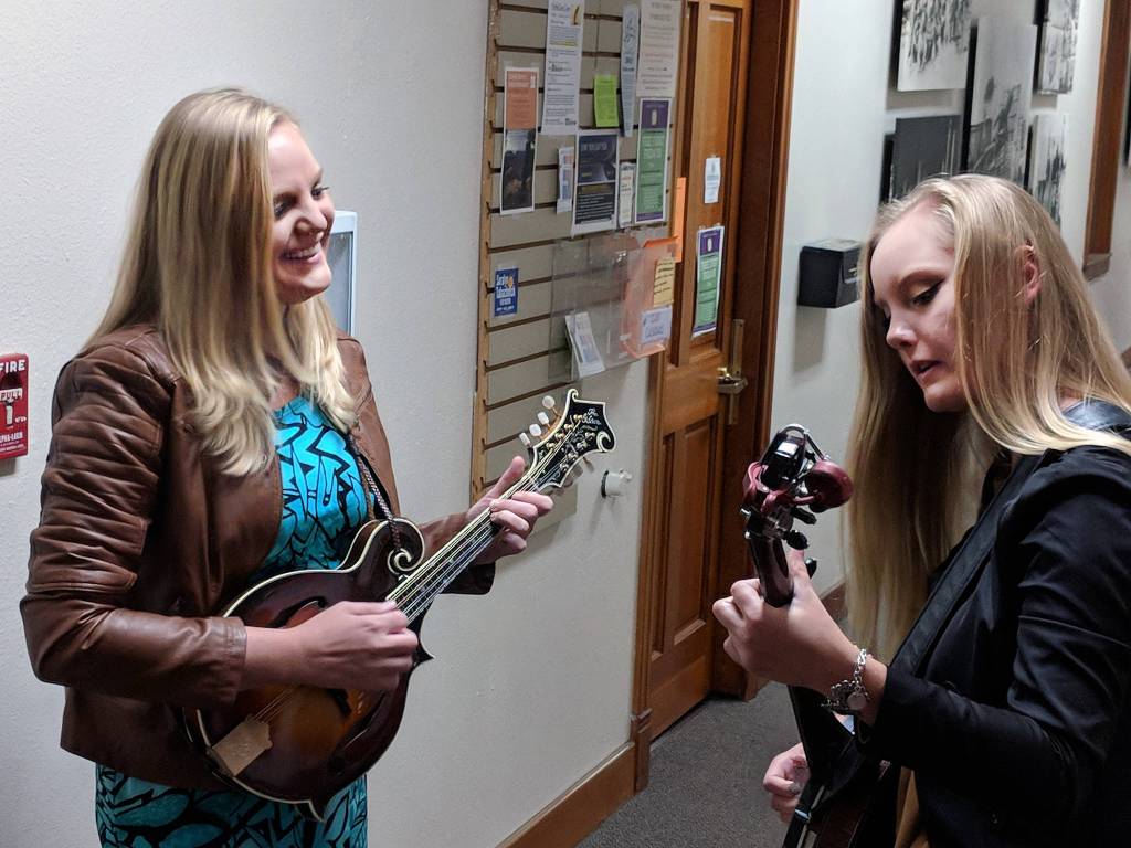 Laura and Abigail Zahasky warm up before playing a bluegrass-influenced set at the Joy of Strings guitarist showcase. The sisters were the only act to include an instrument that wasnt a guitar. Laura Zahasky swapped out a guitar for a mandolin and Abigail Zahasky accompanied her on the banjo. (Ben Hohenstatt | Capital City Weekly)