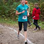 Dzantiki Heeni Middle School eighth grader Mallory Welling runs in the Treadwell Middle School Cross Country Meet on the Treadwell Mine Historic Trails on Thursday. (Nolin Ainsworth | Juneau Empire)