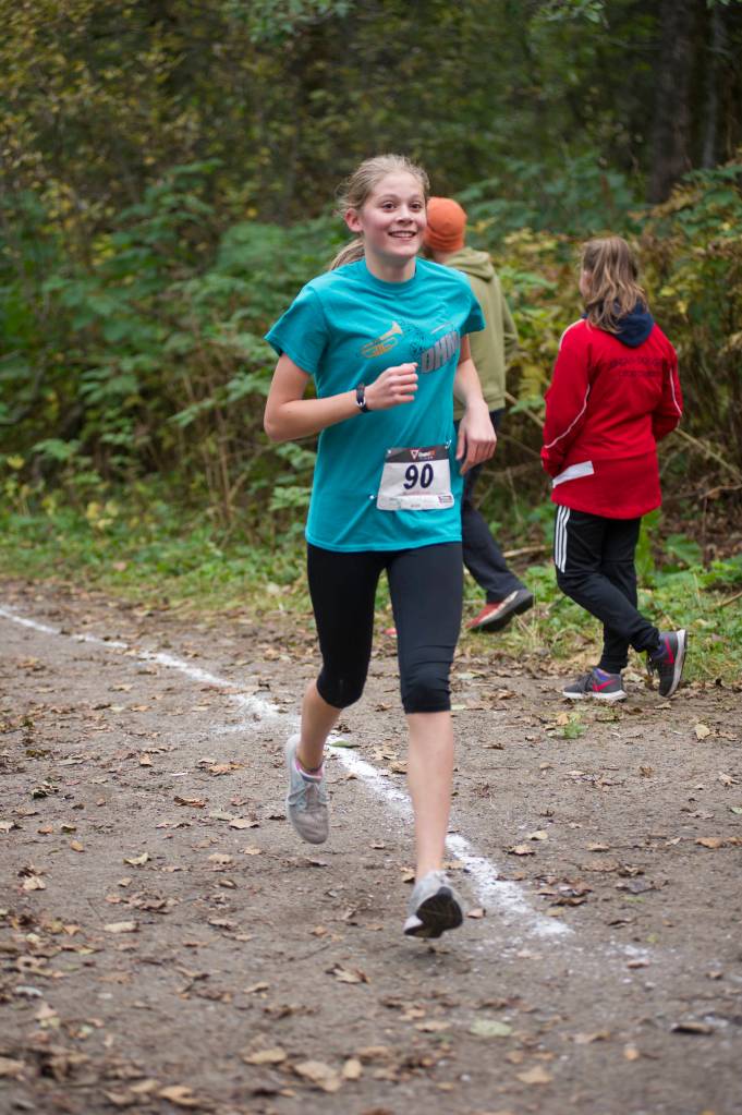Dzantiki Heeni Middle School eighth grader Mallory Welling runs in the Treadwell Middle School Cross Country Meet on the Treadwell Mine Historic Trails on Thursday. (Nolin Ainsworth | Juneau Empire)