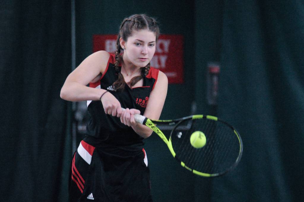 Olivia Moore makes a backhand return against West Anchorage in the first round of the ASAA/First National Bank Alaska State Tennis Championships at the Alaska Club East in Anchorage on Friday, Oct. 5, 2018. (Michael Dinneen | For the Juneau Empire)