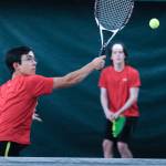 Juneau-Douglas High School senior River Reyes-Boyer reaches for a return against West Anchorage in the first round of the ASAA/First National Bank Alaska State Tennis Championships at the Alaska Club East in Anchorage on Friday, Oct. 5, 2018. (Michael Dinneen | For the Juneau Empire)