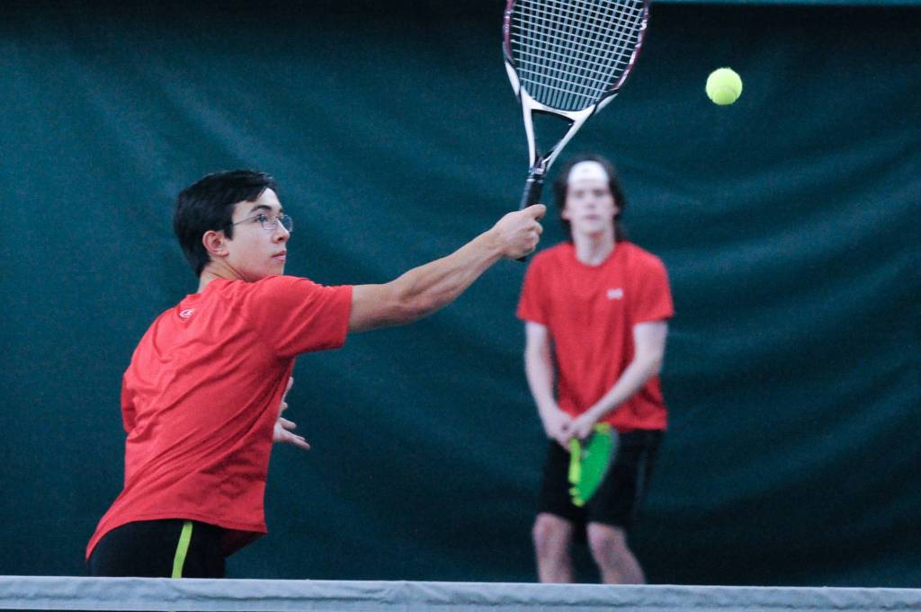 Juneau-Douglas High School senior River Reyes-Boyer reaches for a return against West Anchorage in the first round of the ASAA/First National Bank Alaska State Tennis Championships at the Alaska Club East in Anchorage on Friday, Oct. 5, 2018. (Michael Dinneen | For the Juneau Empire)