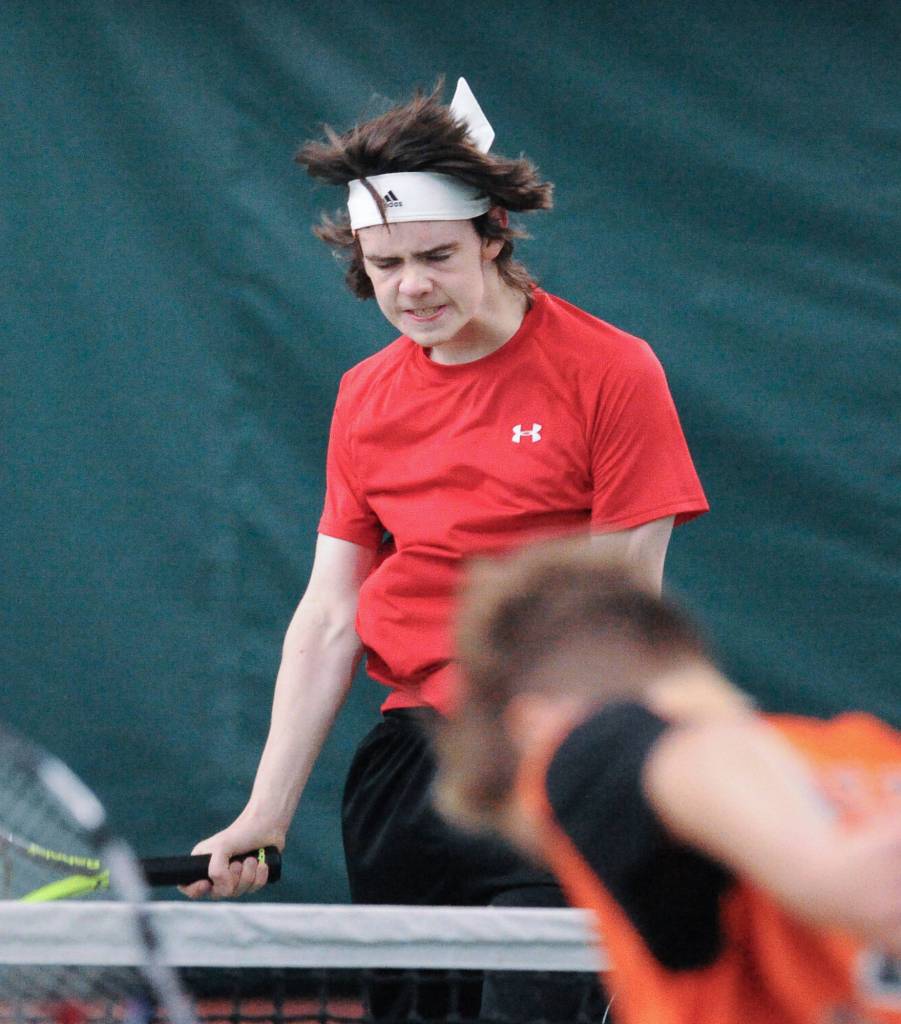 William Smoker reacts to a missed return against West Anchorage in the first round of the ASAA/First National Bank Alaska State Tennis Championships at the Alaska Club East in Anchorage on Friday, Oct. 5, 2018. (Michael Dinneen | For the Juneau Empire)