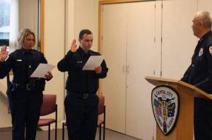 New Juneau Police Department officers Rosie Ostman (left) and Dakota Davies are sworn in by Chief Ed Mercer (right) on Friday, Oct. 5, 2018. (Courtesy Photo | Juneau Police Department)