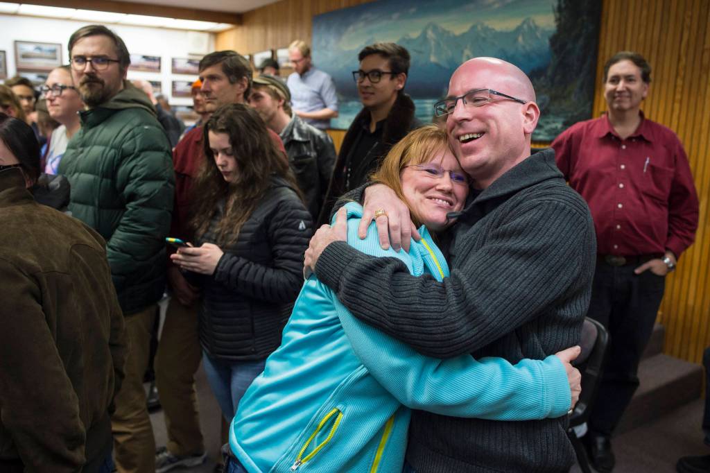 Assembly District 2 Wade Bryson hugs his wife, Christine, as he moves into the second spot during Election night in the Assembly chambers on Tuesday, Oct. 2, 2018. (Michael Penn | Juneau Empire)