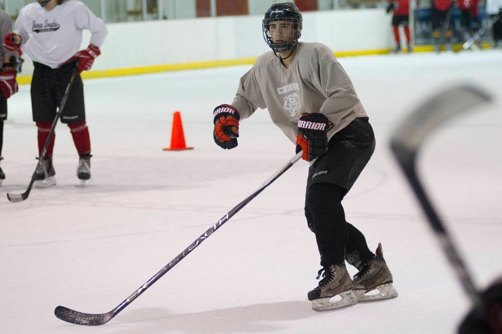Juneau-Douglas High School senior Blake Bixby skates backwards during a drill on Wednesday morning at Treadwell Arena. (Nolin Ainsworth | Juneau Empire)