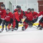 Juneau-Douglas High School teammates skate at top speed at the end of practice on Wednesday morning at Treadwell Arena. Wednesday was the first practice of the season. (Nolin Ainsworth | Juneau Empire)