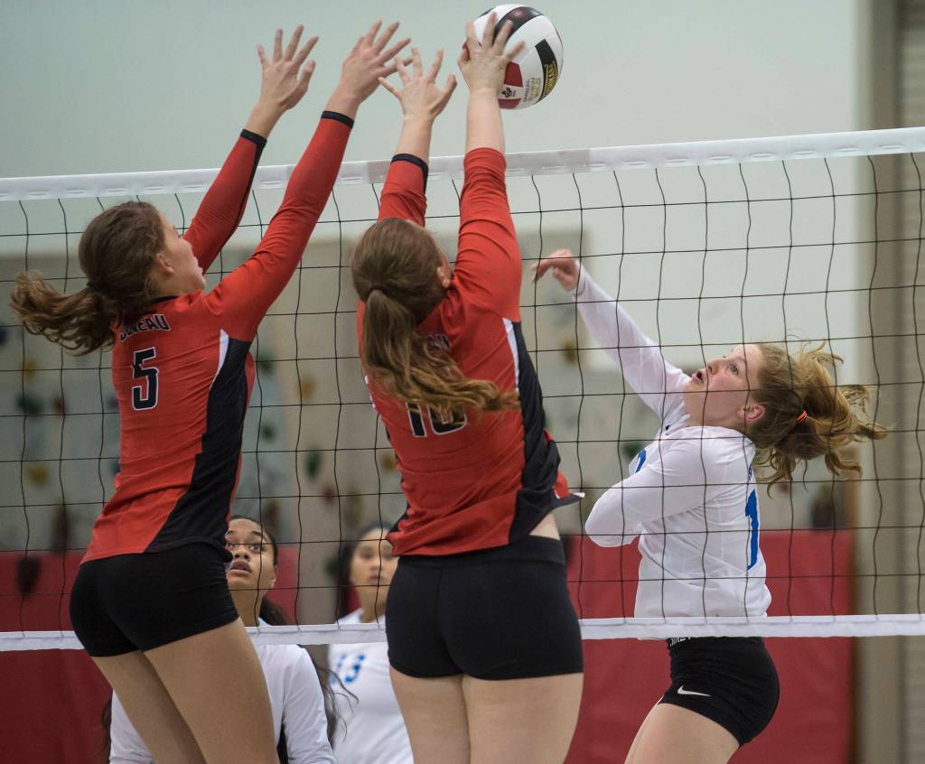 Juneau-Douglas JoJo Griggs, left, and Shaylin Cesar, center, look to block a shot by Thunder Mountains Audrey Welling during the JIVE Tournament at Juneau-Douglas High School on Friday, Oct. 12, 2018, (Michael Penn | Juneau Empire)